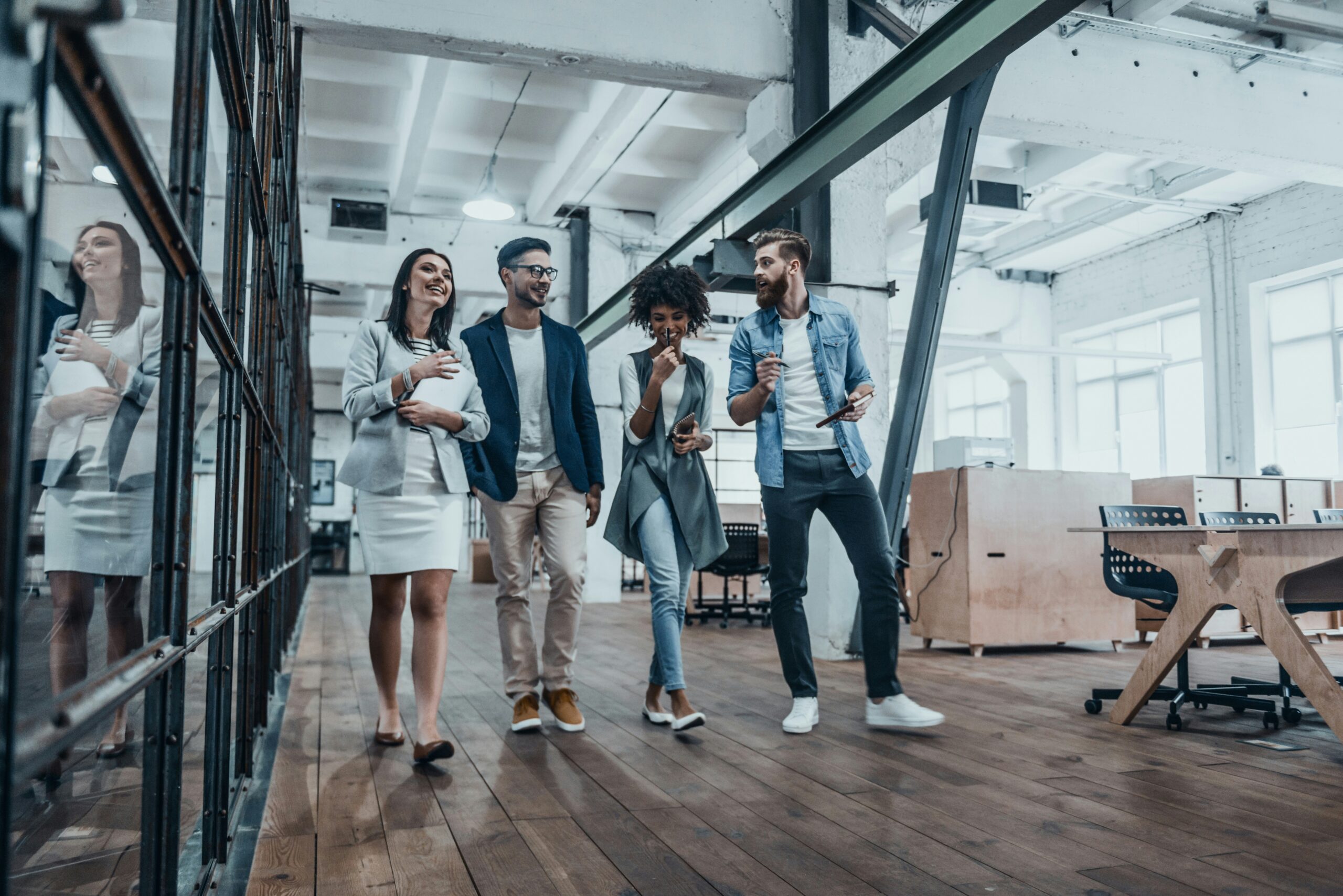 how-to-launch-a-business-in-NJ a group of 4 people walking inside the office