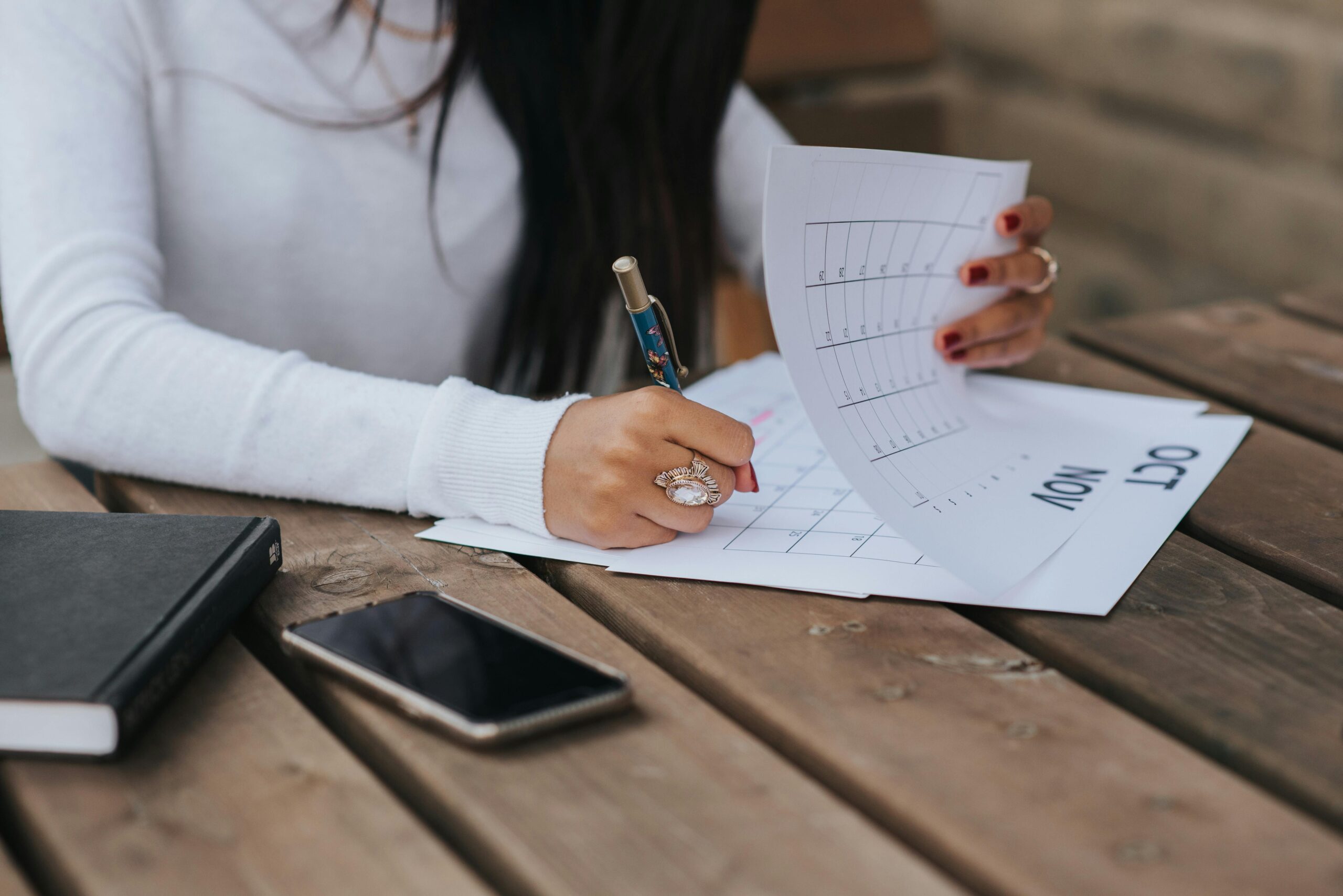 Woman writing on calendar