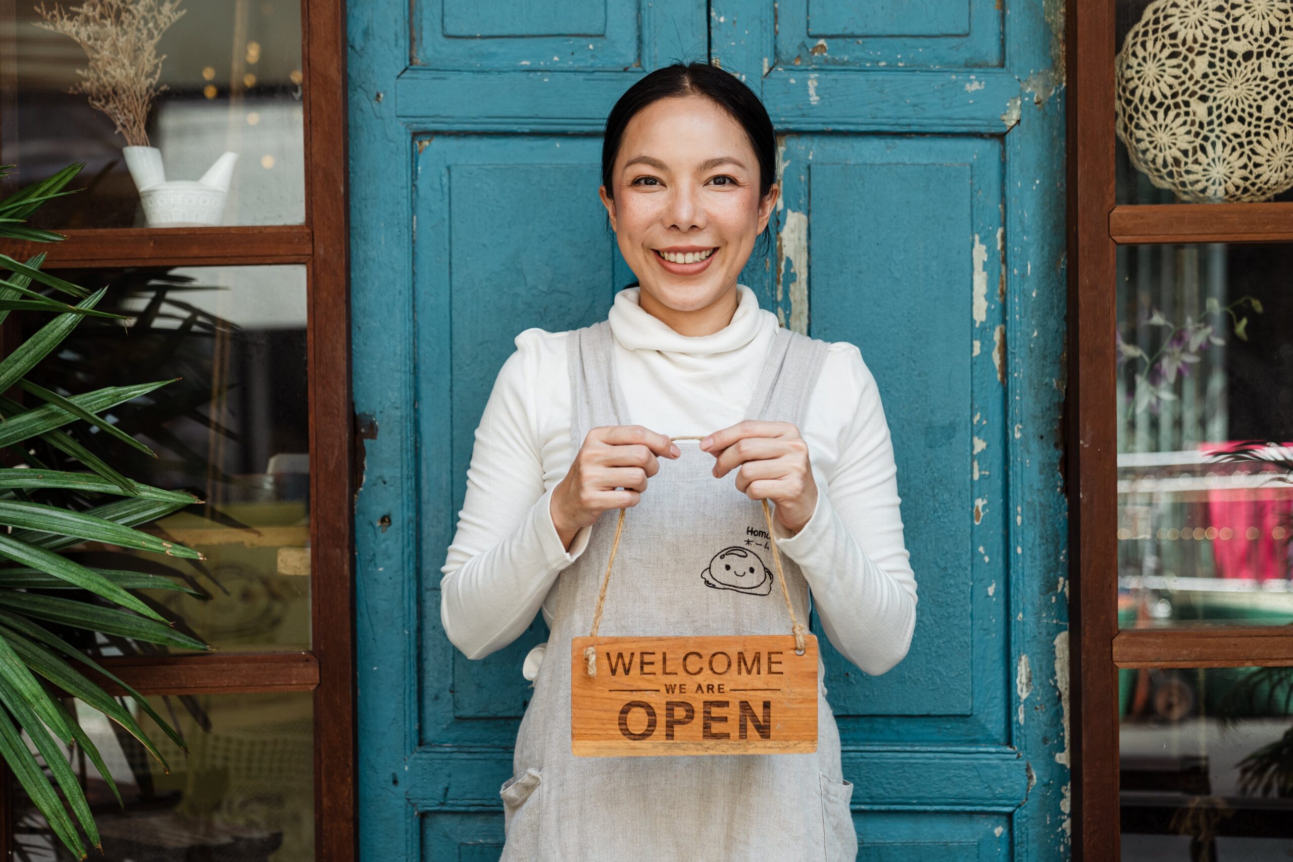 Woman holding an open sign