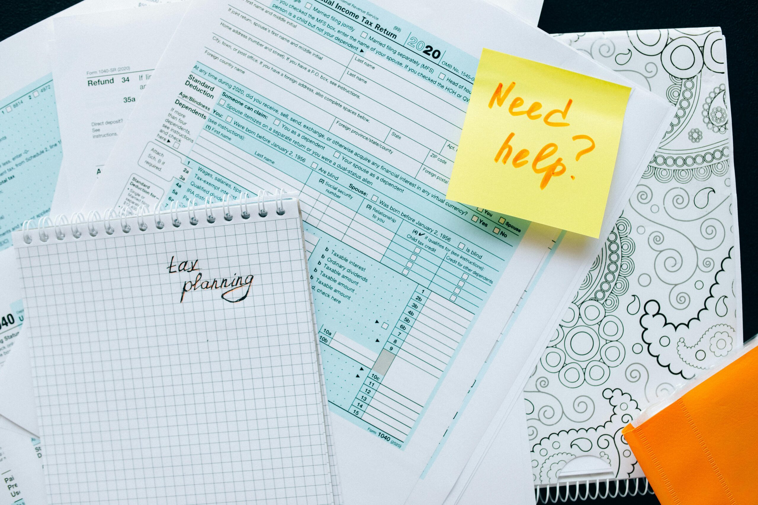 Tax papers and notebook on desk