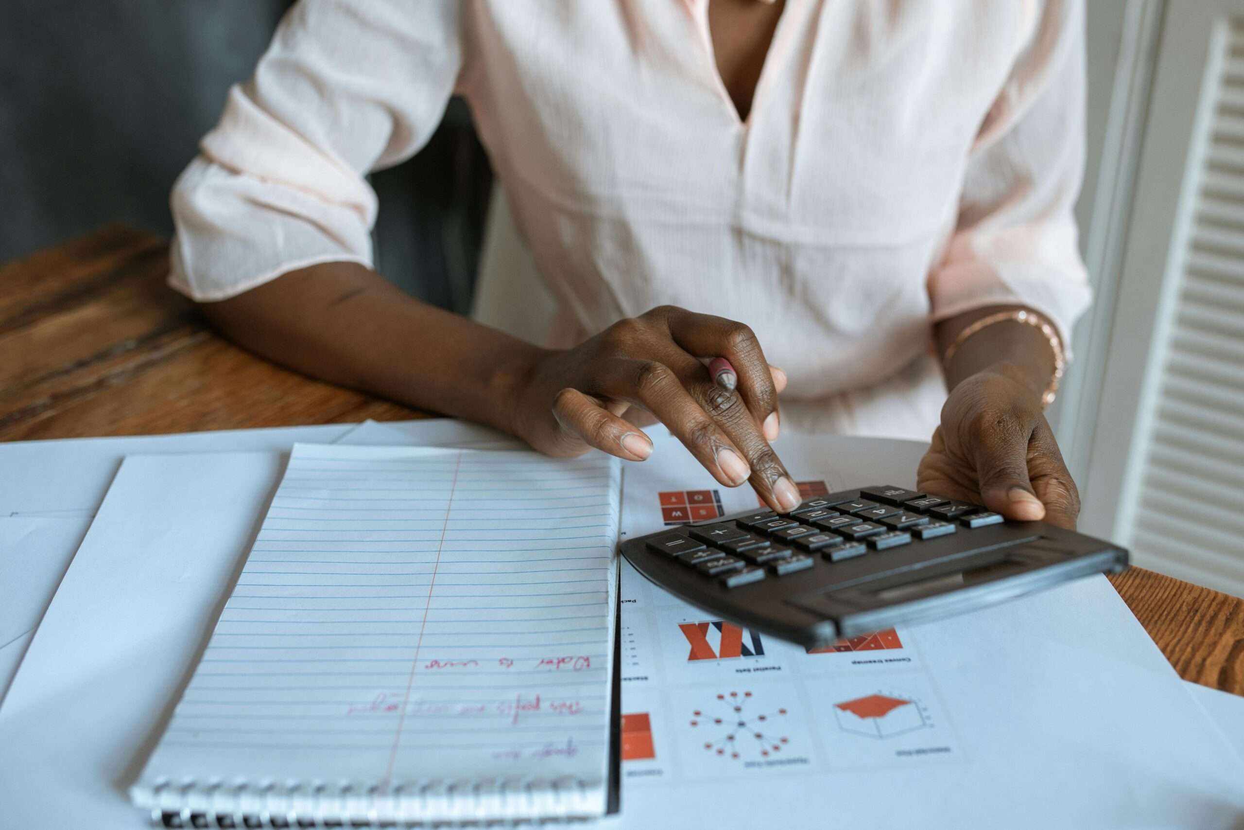 Person using calculator on desk